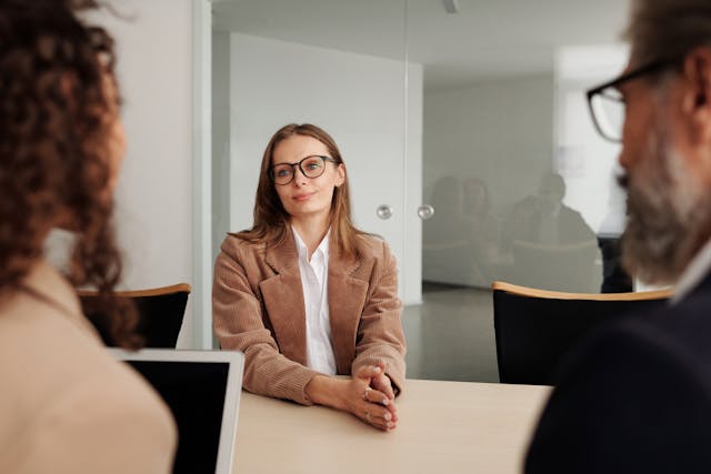 A professional young woman attends a formal job interview